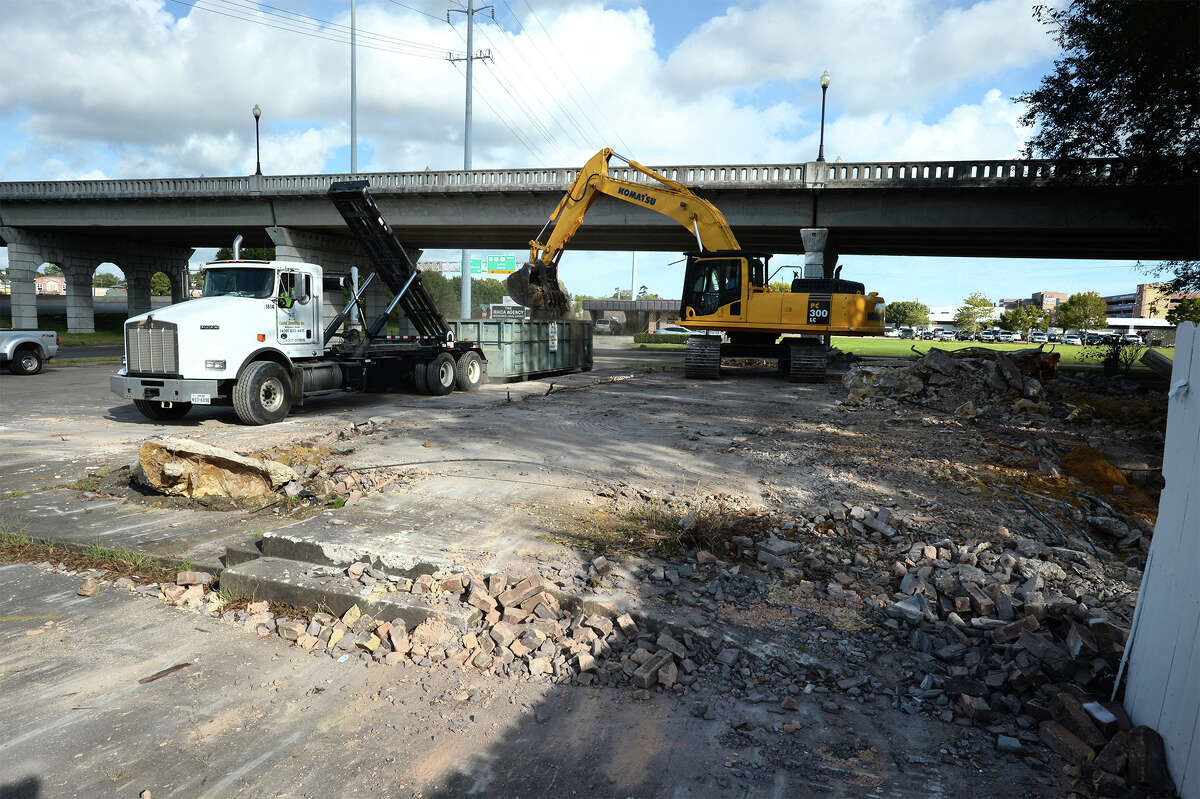 A demolition crew removes rubble Wednesday from the former Gallagher's steak house located next to the Maury Meyers Bridge by Interstate 10 at Laurel Avenue. Photo taken Tuesday, October 19, 2016 Guiseppe Barranco/The Enterprise