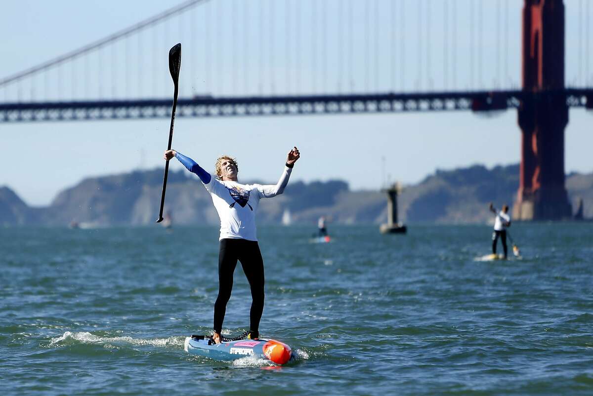 Conor Baxter celebrates finishing first in Red Bull Heavy Water race in San Francisco, Calif., on Wednesday, October 19, 2016.