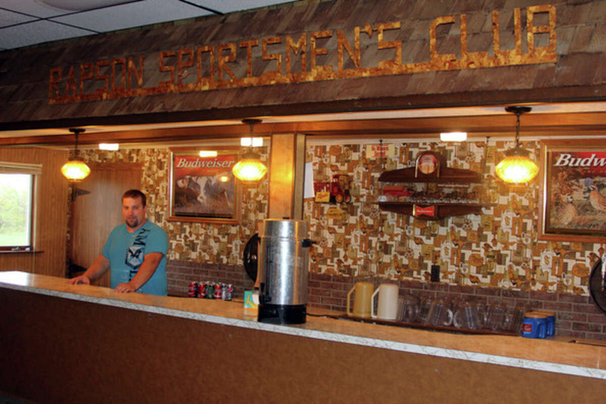 Raymond Peyerk stands behind the historic bar at Rapson Sportsman's Club.