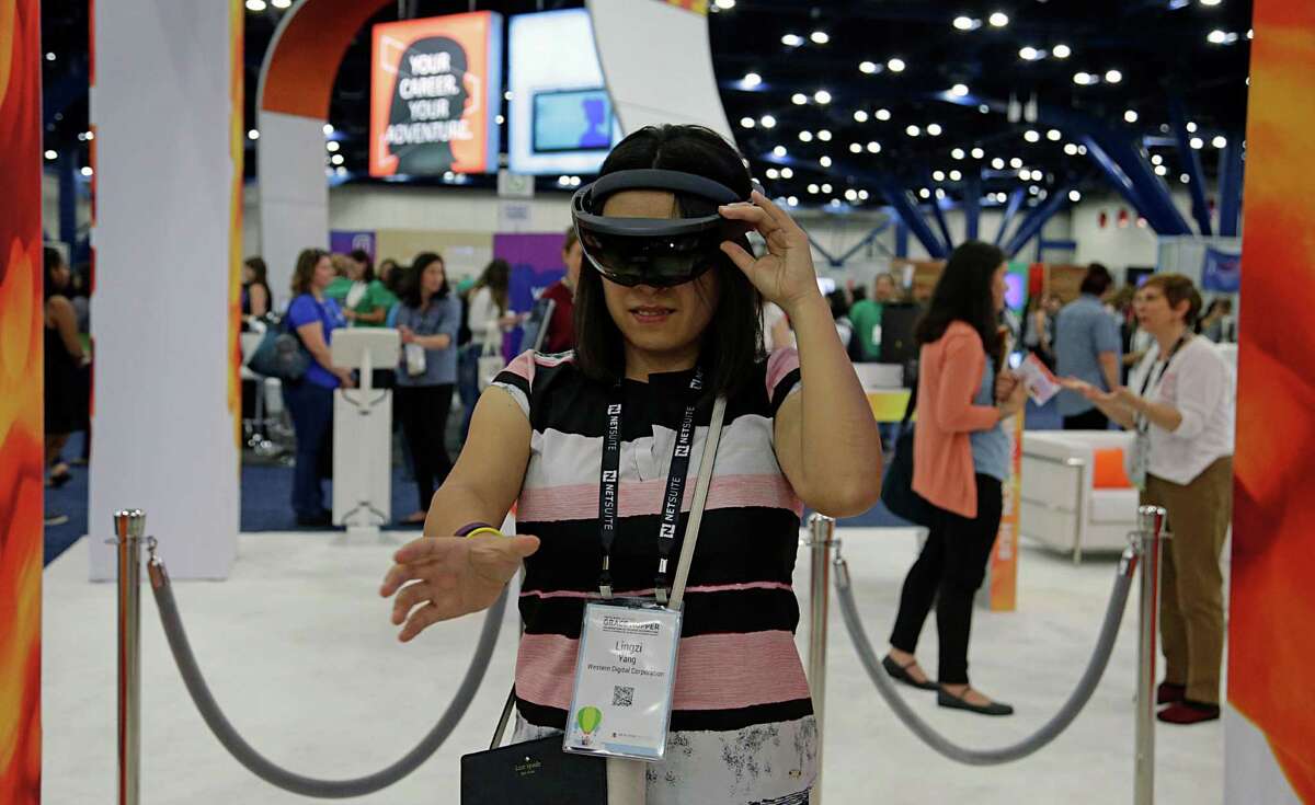 Lingzi Yang demos a pair of Microsoft HoloLens in the Avanade booth during the Grace Hopper Celebration of Women in Computing conference at the George R. Brown Convention Center Oct. 19, 2016, in Houston. ( James Nielsen / Houston Chronicle )
