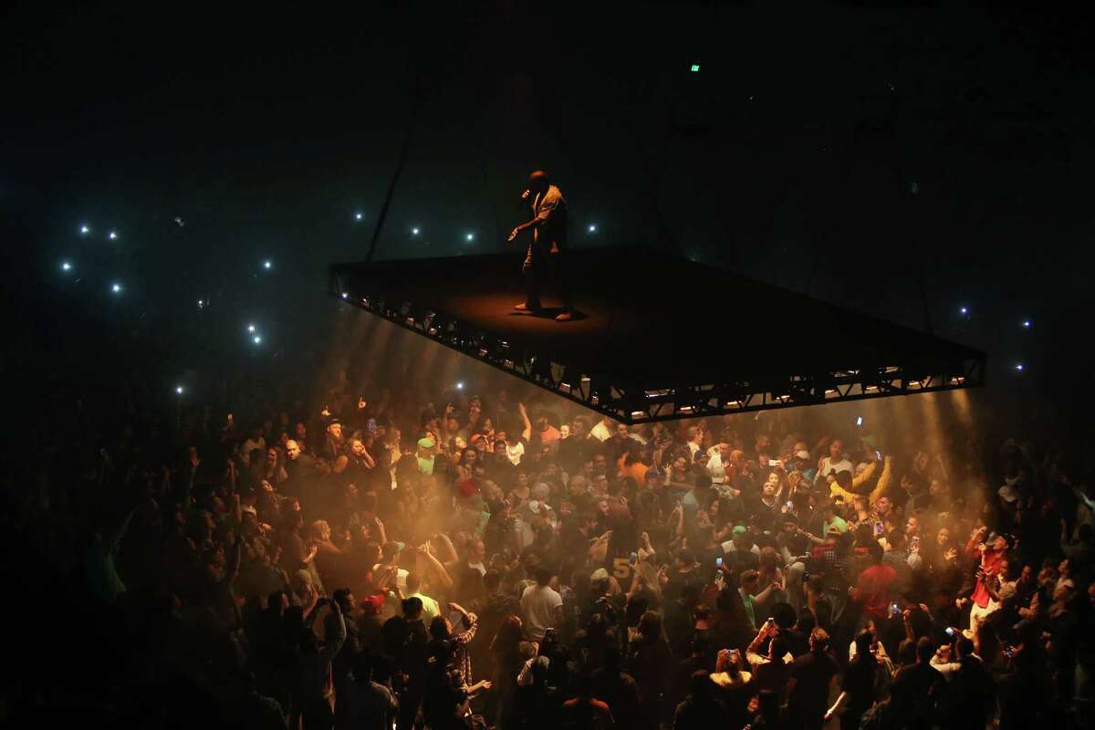 Kanye West performs on a stage that floats above the crowd during his Saint Pablo Tour at KeyArena, Wednesday, Oct. 19, 2016.