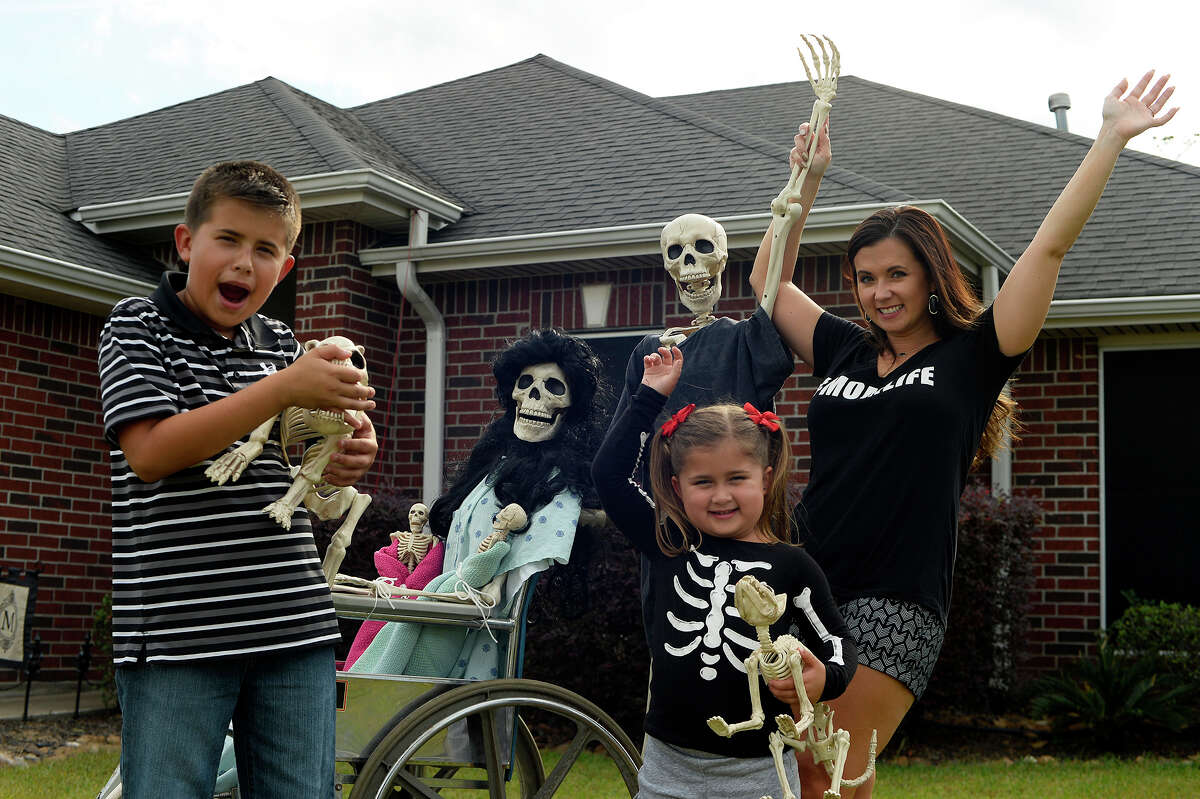 Amy B. Moses and her children, Macy, 4, and Canon, 10, set up a new scene with the skeleton family in their Lumberton yard every day. Fans can follow the Bones family on her Facebook page "Keeping up with the Bones." Photo taken Wednesday 10/19/16 Ryan Pelham/The Enterprise