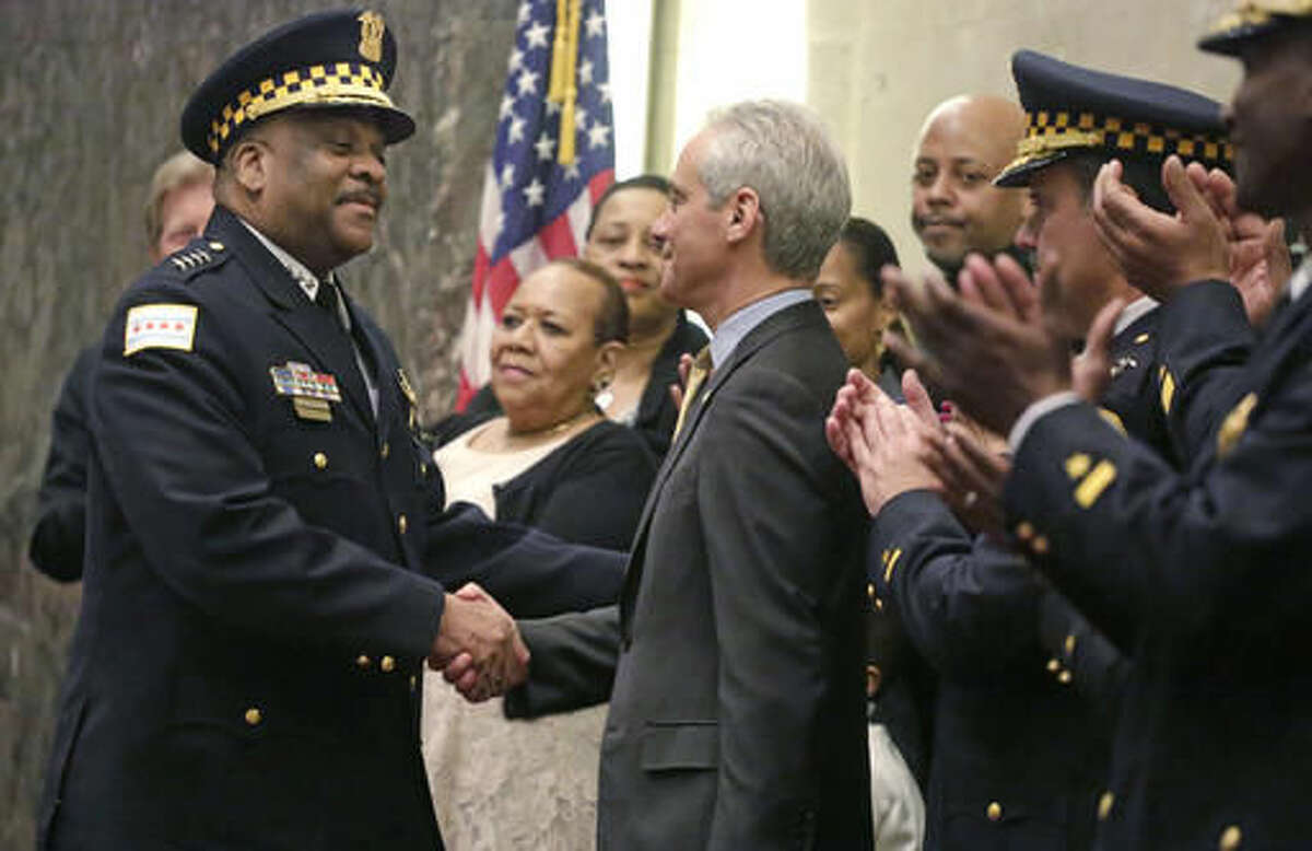 FILE - In this April 13, 2016 file photo, Chicago Mayor Rahm Emanuel shakes hands with Eddie Johnson after swearing him in as the new Chicago police superintendent in Chicago. Johnson replaced former superintendent Garry McCarthy, in the wake of the release of a police video showing Chicago Police Department officer Jason Van Dyke, a white police officer, shooting Laquan McDonald, a black teen, 16 times in all, as he lay mortally wounded. (AP Photo/M. Spencer Green, File)
