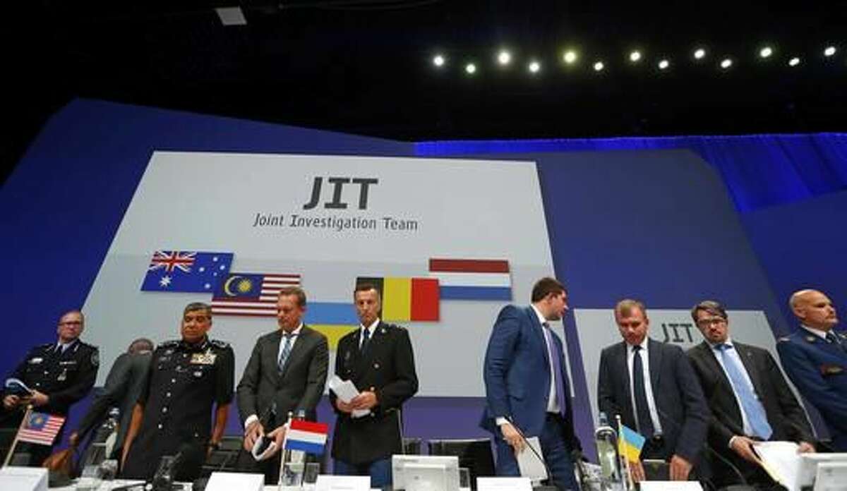 Members of the Joint Investigation Team (JIT) get to their feet after a press conference on the preliminary results of the investigation into the shooting-down of Malaysia Airlines jetliner flight MH17 in Nieuwegein, Netherlands, Wednesday, Sept. 28, 2016. The disaster claimed 298 lives. (AP Photo/Peter Dejong)