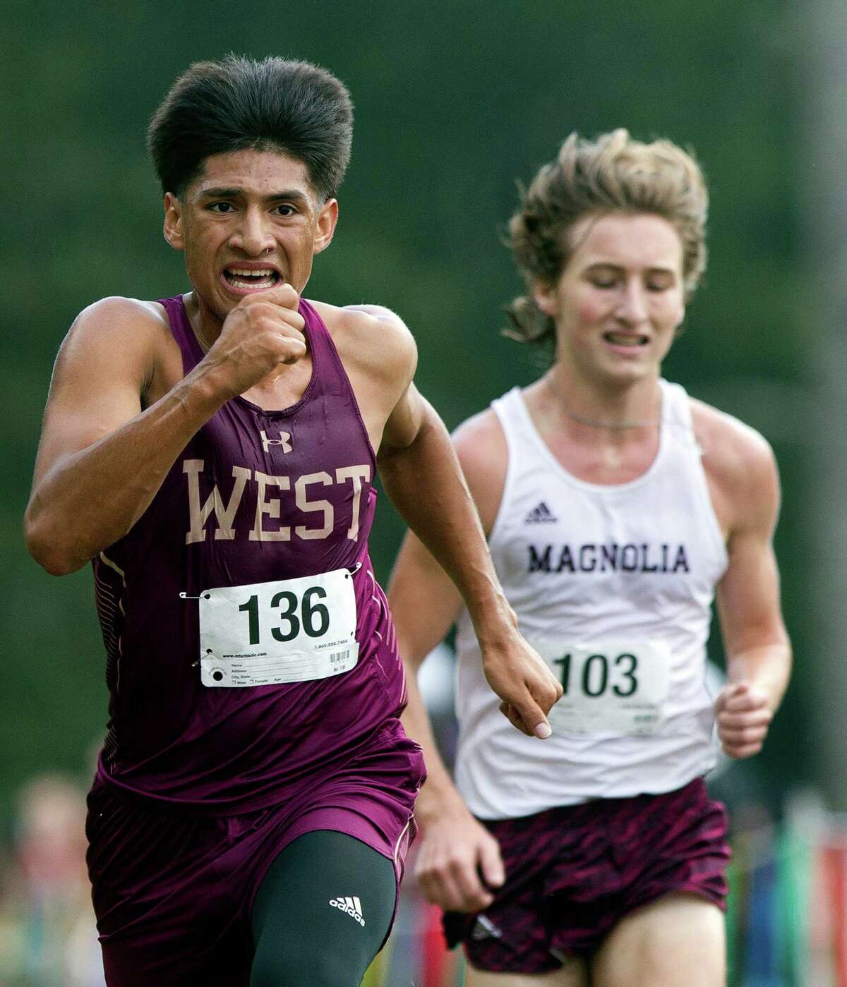 Magnolia West's Jonathan Gomez, left, competes against Magnolia's Brendan Gilbert during the District 20-5A varsity boys high school cross country meet at Camp Misty Meadows Thursday, Oct. 20, 2016, in Conroe.