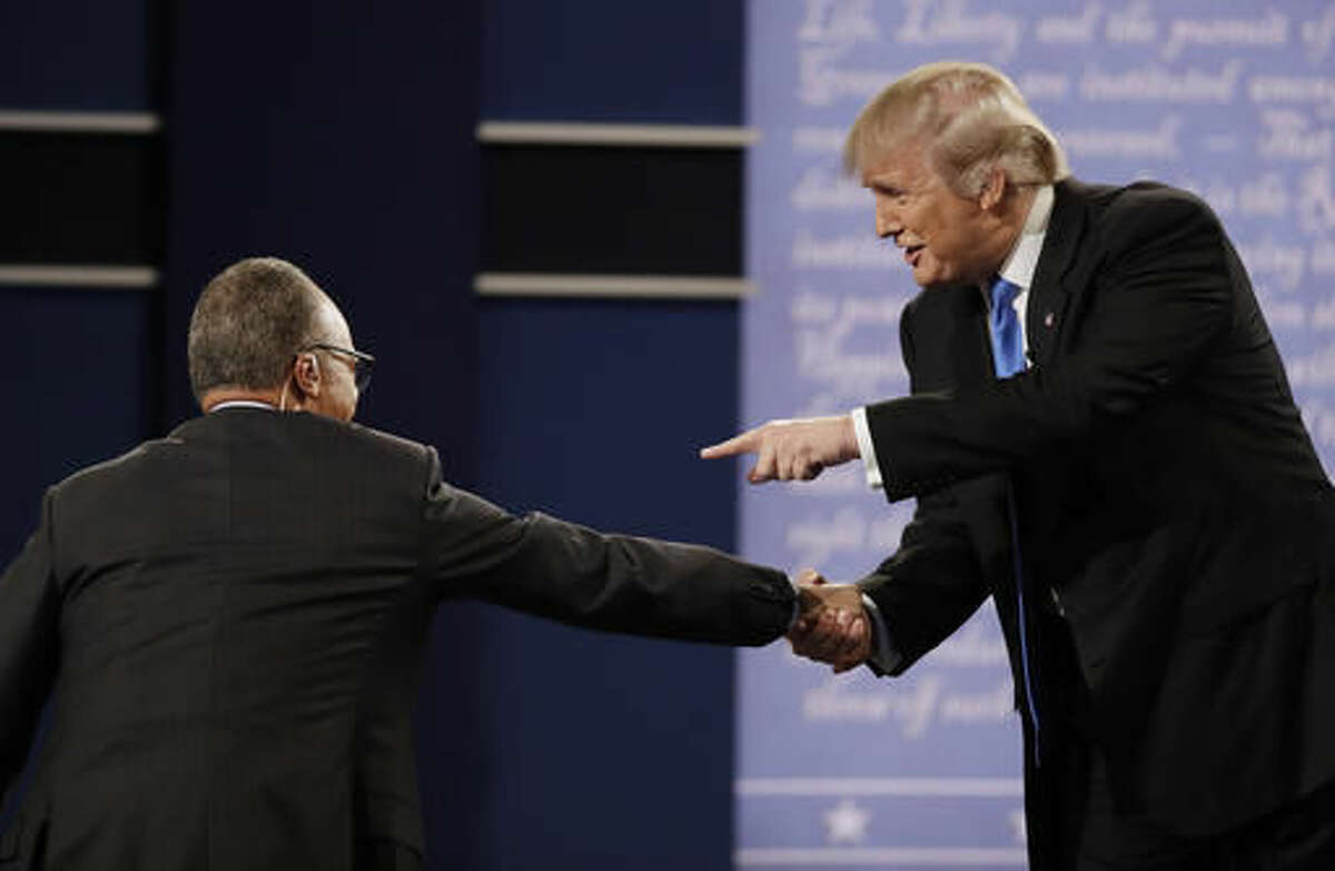 Republican presidential nominee Donald Trump shakes hands Moderator Lester Holt, anchor of NBC Nightly News, following the presidential debate with Democratic presidential nominee Hillary Clinton at Hofstra University in Hempstead, N.Y., Monday, Sept. 26, 2016. (AP Photo/Patrick Semansky)