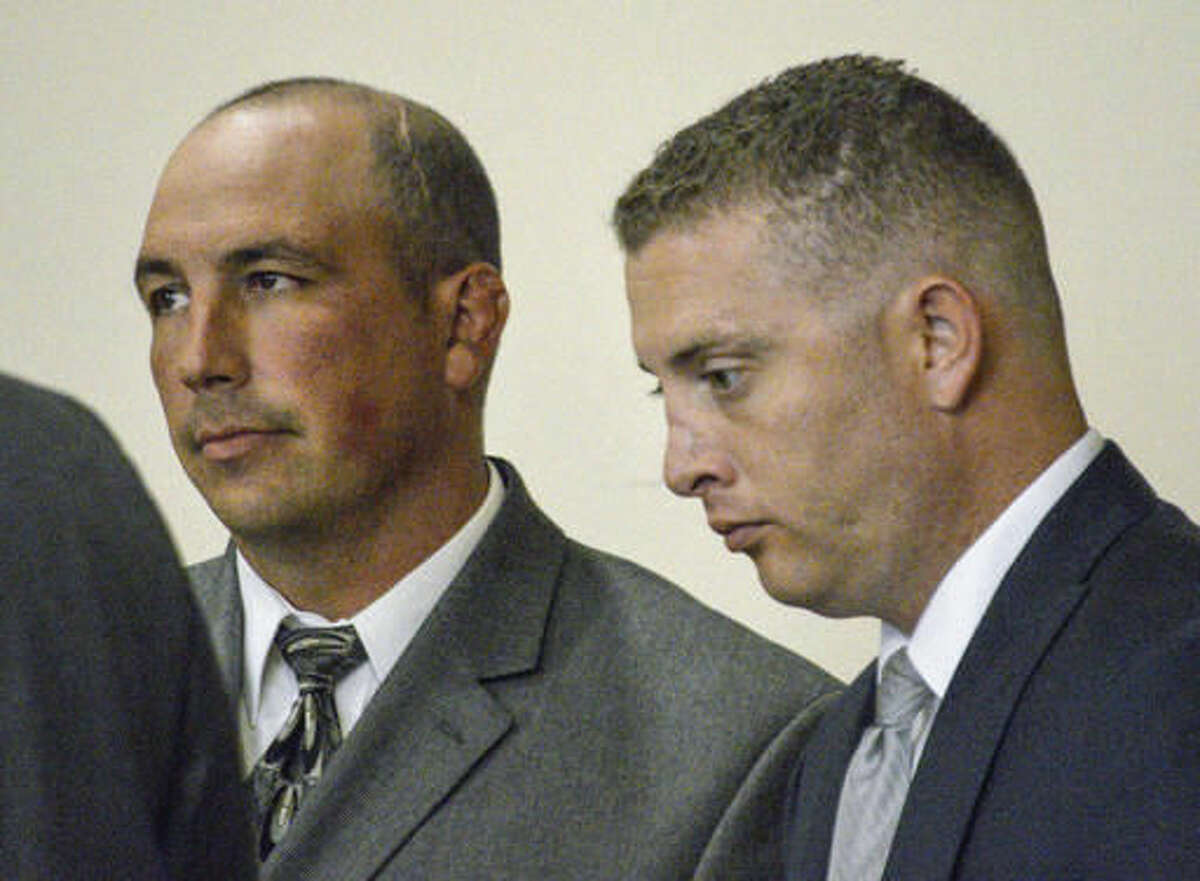 FILE - In this Aug. 18, 2015 file photo, former Albuquerque Police detective Keith Sandy, left, and Officer Dominique Perez speak with attorneys during a preliminary hearing in Albuquerque, N.M. The two Albuquerque police officers who opened fire on a homeless man in a fatal shooting that led to protests and national outcry two years ago will stand trial for murder this month, with jury selection in the case set to begin Monday, Sept. 12. (AP Photo/Russell Contreras, File)