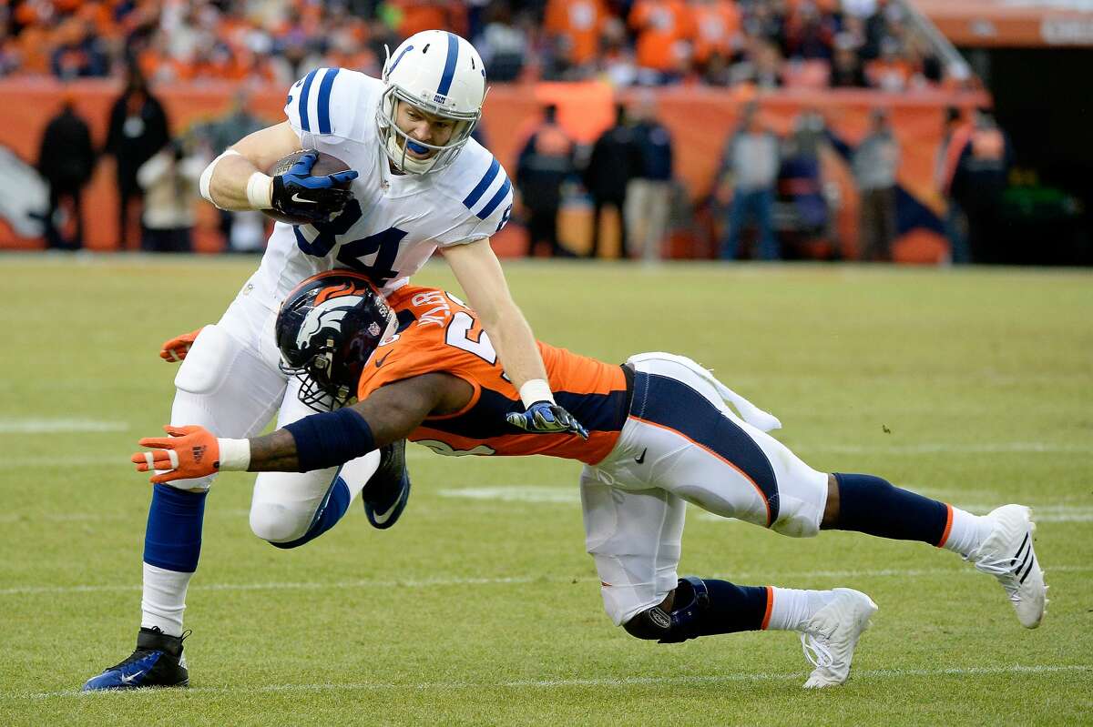 DENVER, CO - JANUARY 11: Jack Doyle #84 of the Indianapolis Colts is tackled by Von Miller #58 of the Denver Broncos during a 2015 AFC Divisional Playoff game at Sports Authority Field at Mile High on January 11, 2015 in Denver, Colorado. (Photo by Harry How/Getty Images)