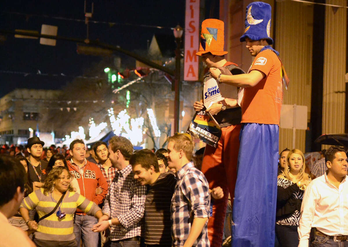 In this January 2013 file photo, street performers on Flores Street dazzle attendees of the UETA Jamboozie in downtown Laredo. (Photo by Laredo Morning Times)