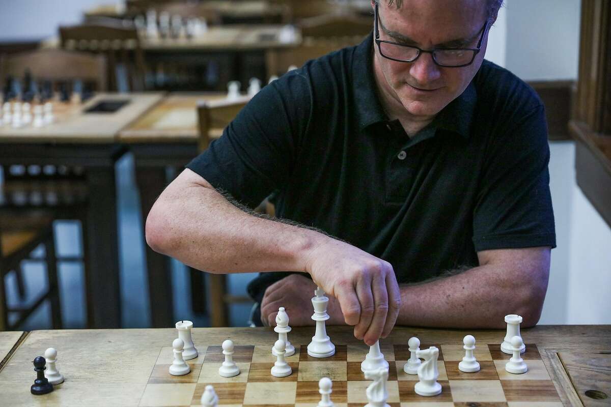John Donaldson, chess room director and chess master plays chess with himself while sitting for a portrait, at the Mechanics' Institute Chess Room in downtown San Francisco, California, on Wednesday, Oct. 19, 2016.