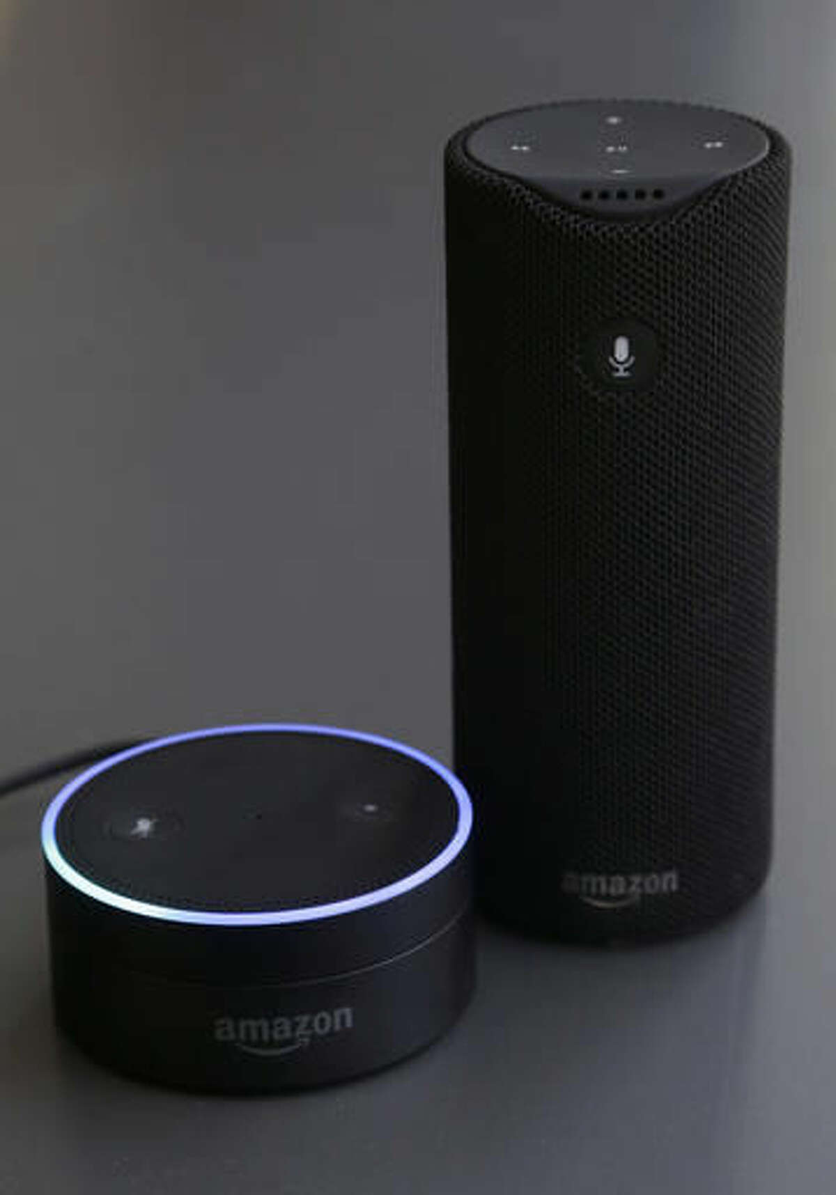 FILE - This Wednesday, March 2, 2016, file photo shows an Echo Dot, left, and an Amazon Tap in San Francisco. The Amazon Echo, which listens to you, answers questions and carries out tasks like calling an Uber or turning on your lights, is finding a place in millions of living rooms. The Dot and the portable Tap give the Echo's Alexa software even broader reach. (AP Photo/Jeff Chiu, File)