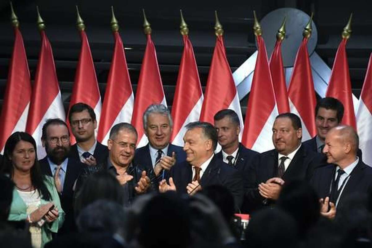Hungarian Primie Minister Viktor Orban, centre, applauds, during the Fidesz party's event after the referendum in the Balna Budapest Cultural Center in Budapest, Hungary, Sunday, October 2, 2016. Hungarians overwhelmingly supported the government in a referendum on Sunday called to oppose any future, mandatory European Union quotas for accepting relocated asylum seekers. But nearly complete official results showed the ballot was invalid due to low voter turnout.(Szilard Koszticsak/MTI via AP)