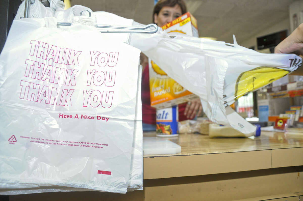 In this file photo, a shopper has his items placed in a plastic bag at G's Meat Market.