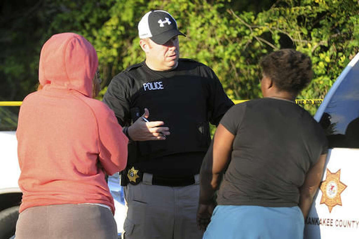 In this Oct. 2, 2016 photo Kankakee County Sheriff's police Lt. Chad Gessner talks at scene of a homicide first discovered on Sunday afternoon in Pembroke Township, Ill. Police in northeastern Illinois said they're investigating multiple homicides in the township, which happened in less than 36 hours. (Scott Anderson/The Daily Journal via AP)