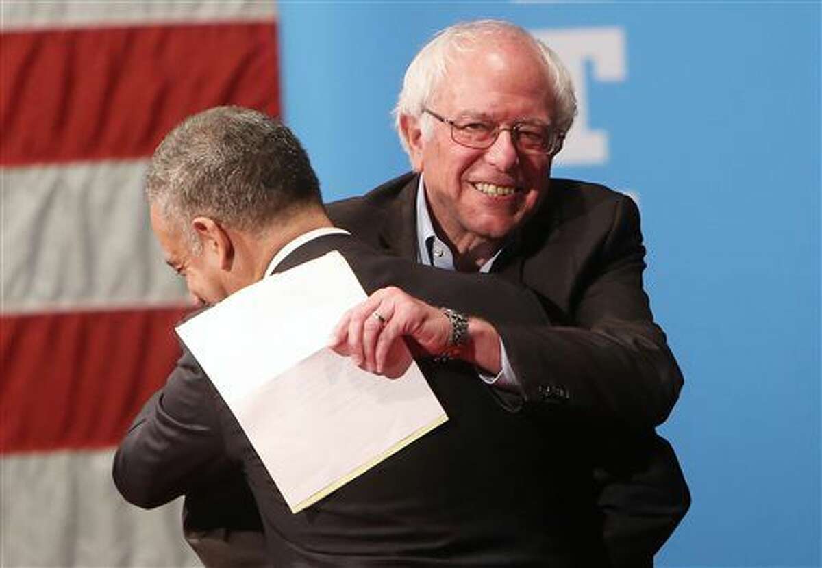 Sen. Bernie Sanders, I-Vt., greets Russ Feingold, Democratic candidate for the U.S. Senate, as he enters the stage to campaign for Democratic presidential candidate Hillary Clinton at Monona Terrace Community and Convention Center in Madison, Wis., Wednesday, Oct. 5, 2016. (Amber Arnold/Wisconsin State Journal via AP)