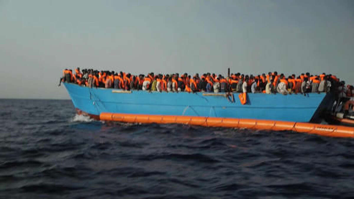Migrants are crowded on to the vessel in the Mediterranean Sea off the coast of Libya in this Tuesday Oct. 4, 2016 image taken from video. At least 33 people died on Tuesday trying to reach Europe by crossing the Mediterranean Sea from Libya. (AP Photo)