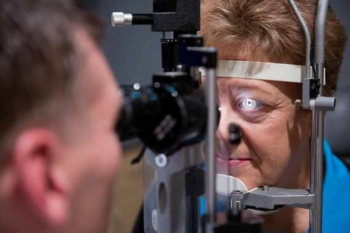 In this Friday, Sept. 16, 2016 photo, Dr. Lance Kugler examines Cheryl Henry's left eye during a follow-up visit at Kugler Vision in Omaha, Neb. (Rebecca Gratz /Omaha World-Herald via AP)