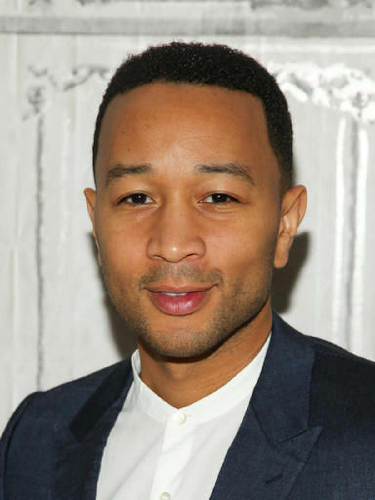 File- This March 9, 2016, file photo shows John Legend at AOL's BUILD Speaker Series to discuss his 10-episode WGN Network series "Underground" at AOL Studios in New York. The Oscar- and Grammy-winning artist is set to perform at the dedication of a recently renovated $2.5 million theater that’s named in his honor.(Photo by Andy Kropa/Invision/AP, File)