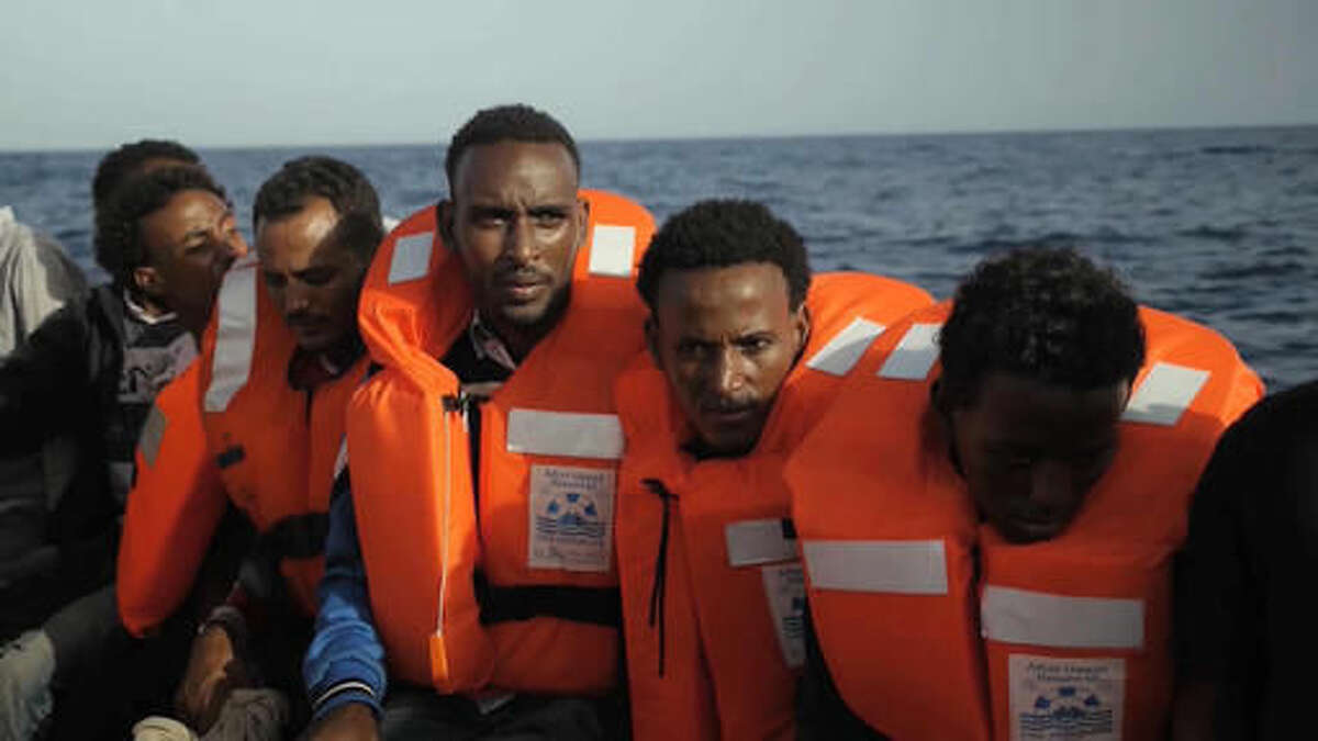 A rescue boat is filled with migrants taken from a vessel in the Mediterranean Sea off the coast of Libya in this Tuesday Oct. 4, 2016 image taken from video. At least 33 people died on Tuesday trying to reach Europe by crossing the Mediterranean Sea from Libya. (AP Photo)