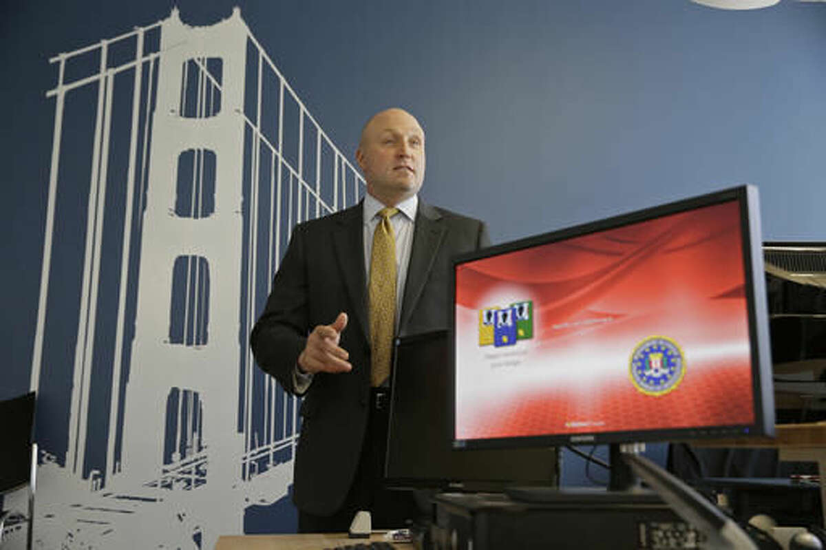 In this photo taken Tuesday, Sept. 27, 2016, FBI Special Agent Jack Bennett answers a question while posing in one of the bureau's modernized offices in San Francisco. The FBI’s new leader in San Francisco is a former drug investigator who developed expertise in technology that put him at the center of the government’s effort to unlock an iPhone used by one of the San Bernardino shooters. Bennett now has oversight responsibilities for Silicon Valley. (AP Photo/Eric Risberg)