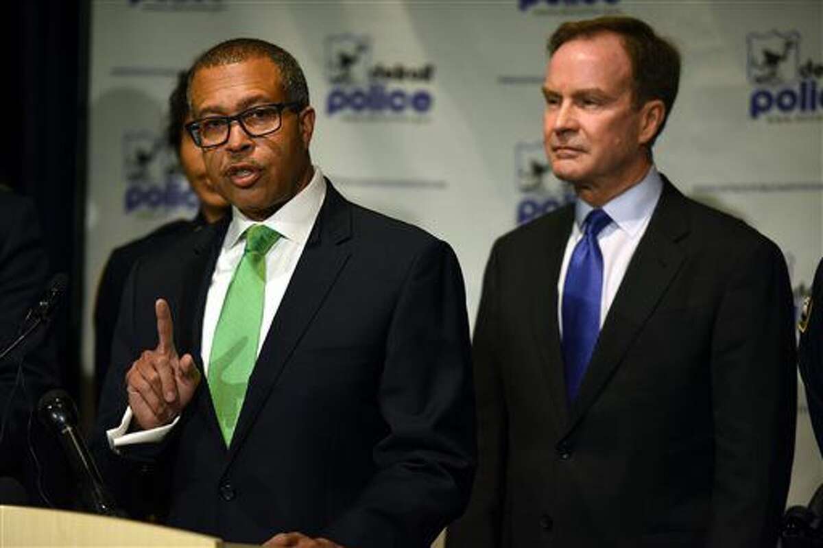 Detroit Police Chief James Craig, left, speaks at a press conference where he and Michigan Attorney General Bill Schuette, right, announced felony charges for Nheru G. Littleton, 40 of Detroit, for making threats against the lives of police officers via social media, Wednesday, Oct. 5, 2016 at the Detroit Public Safety Headquarters. (Tanya Moutzalias/The Ann Arbor News-MLive.com via AP)