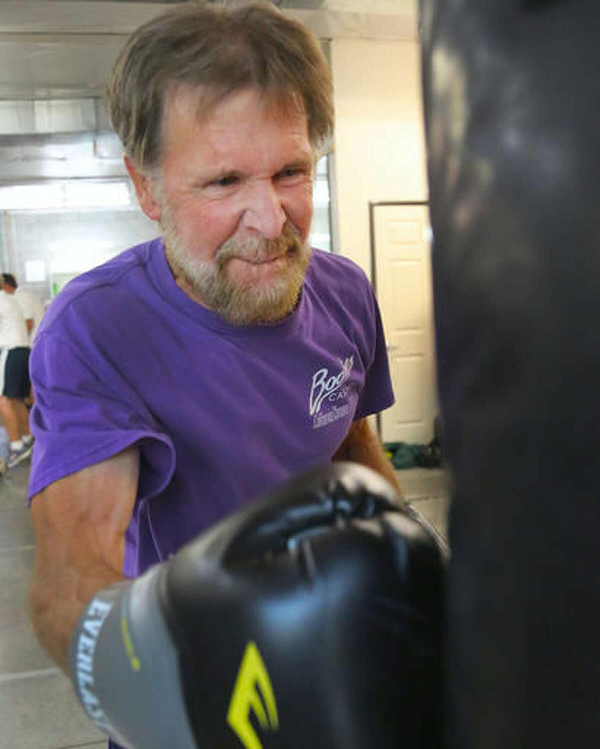 In this Monday, Sept. 19, 2016 photo, Rick Gutierrez punches a body bag during the Parkinson's boxing program at the Tazmanian Boxing Club in Carson City, Nev. (Jim Grant /Nevada Appeal via AP)