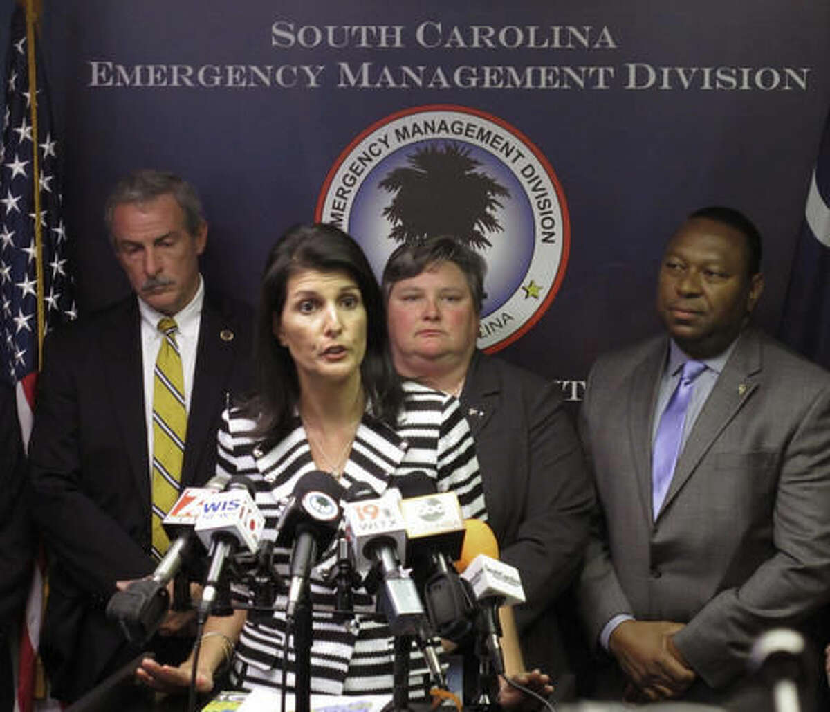 Gov. Nikki Haley announces that she plans to call for the evacuation of about 1 million people from South Carolina's coast as Hurricane Matthew threatens on Tuesday, Oct. 4, 2016, at the South Carolina Emergency Management Division headquarters in Pine Ridge, S.C. People along the East Coast entered better-safe-than-sorry mode Tuesday, flocking to hardware stores, grocery aisles and gas stations as Hurricane Matthew marched toward Florida, threatening to become the first hurricane to hit the state's Atlantic coast in over a decade. (AP Photo/Jeffrey Collins)