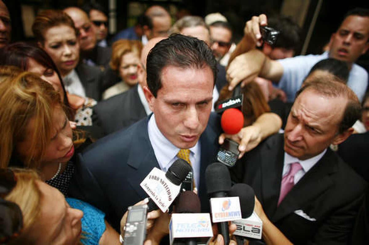 FILE - In this June 23, 2010 file photo, then-Puerto Rican Sen. Hector Martinez-Maldonado talks to reporters outside federal court in San Juan. The Supreme Court seems skeptical of Martinez-Maldonado's bid to avoid a second trial on bribery charges. The justices heard the first arguments of their new term Tuesday, Oct. 4, 2016, first up was an appeal from Martinez-Maldonado and a prominent businessman. (AP Photo/Ricardo Arduengo, File)