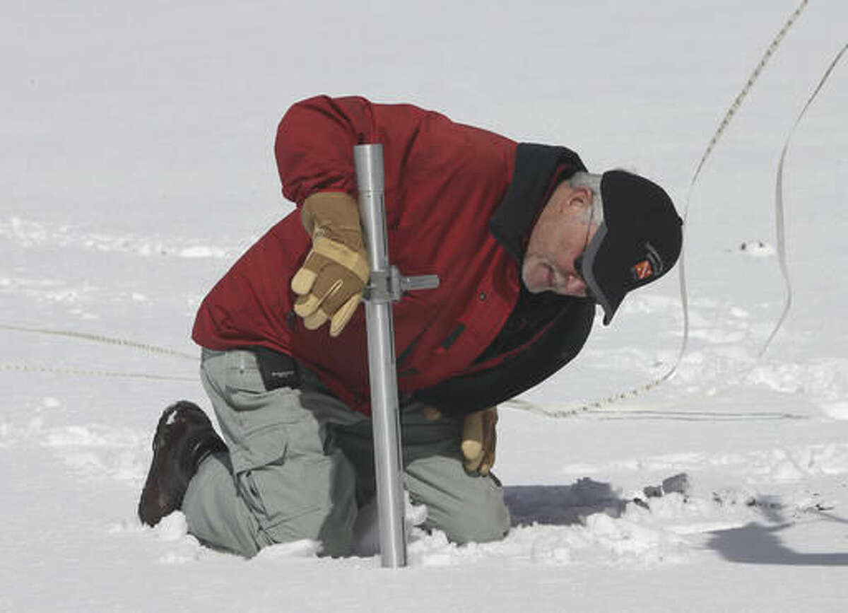 FILE - In this March 30, 2016, file photo, Frank Gehrke, chief of the California Cooperative Snow Surveys Program for the Department of Water Resources, checks the snowpack depth while performing a snow survey at Phillips Station near Echo Summit, Calif. State regulators said Wednesday, Oct. 5, 2016, water conservation continues to slip in drought-stricken California after officials lifted mandatory cutbacks. (AP Photo/Rich Pedroncelli, File)