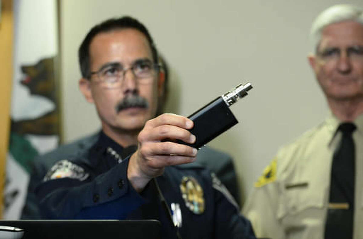El Cajon Police Department Capt. Jeffery Davis holds up a vape device similar to the one that they claim that Alfred Olango was holding when he was shot during at a news conference held on Friday Sept. 30, 2016, in El Cajon, Calif. The El Cajon police department released video footage of the shooting at the news conference. (AP Photo/Denis Poroy)
