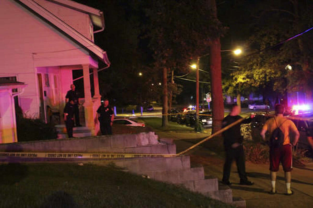 In this Tuesday, Oct. 4, 2016 photo provided by The Miami Student, a university newspaper, police officers investigate a crime scene in Oxford, Ohio, where two Miami University students were shot and wounded near the campus. The male students were shot and wounded while trying to buy a car that was posted for sale on Craigslist, police said. The students were shot during an apparent robbery Tuesday night at a house near campus. (A.J. Newberry/The Miami Student via AP)