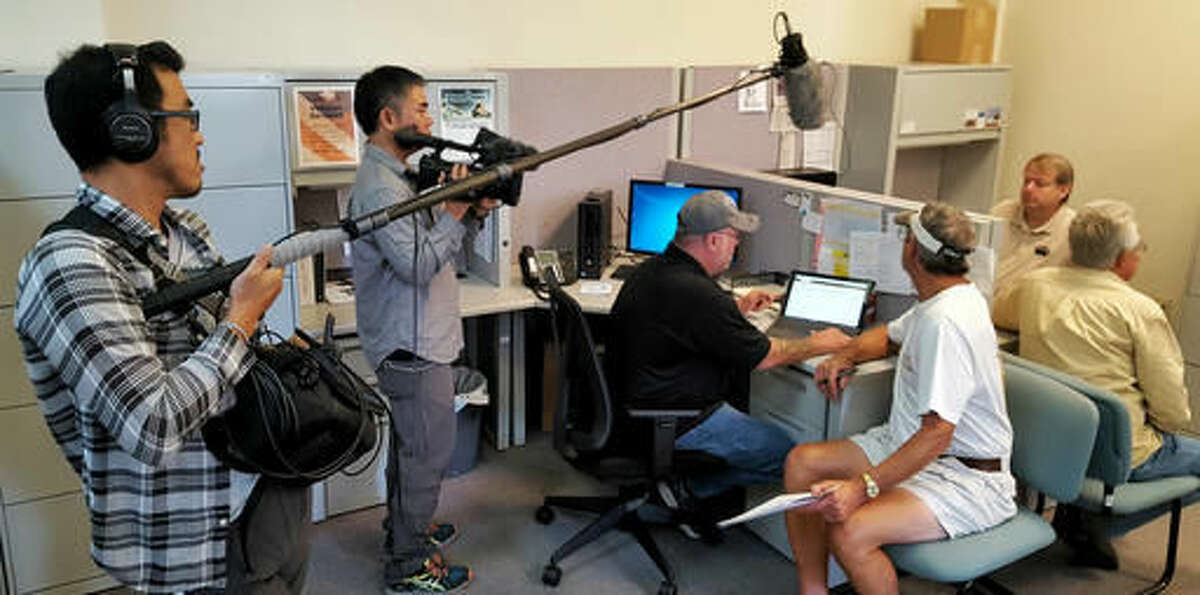 In this photo taken on Sept. 15, 2016, a Japanese television crew from NHK-TV interviews unemployed coals miners at the CareerLink office in Waynesburg, Pa., about their new job prospects. The plight of Greene County's mining industry was the focus of numerous documentaries in recent months, including ones produced by journalists from Israel, Australia, Germany and France. (Mike Jones/Observer-Reporter via AP)