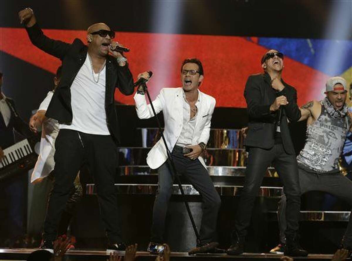 Singer Marc Anthony, center, performs with the Cuban duo Gente de Zona during the Latin Billboard Awards, Thursday, April 30, 2015 in Coral Gables, Fla. 
