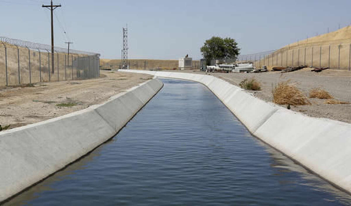 FILE - In this Tuesday, July 21, 2015 file photo, water flows down a diversion canal operated by the Byron-Bethany Irrigation District, near Byron, Calif., that is drawn out of a channel leading to to the William O. Banks pumping plant. State regulators said Wednesday, Oct. 5, 2016, water conservation continues to slip in drought-stricken California after officials lifted mandatory cutbacks. (AP Photo/Rich Pedroncelli, File)