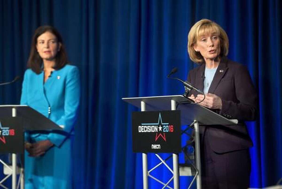 Incumbent Republican U.S. Sen. Kelly Ayotte, left, listens as Democratic challenger Gov. Maggie Hassan speaks during a live televised debate by New England Cable News at New England College Monday, Oct. 3, 2016, in Henniker, N.H. (AP Photo/Jim Cole)