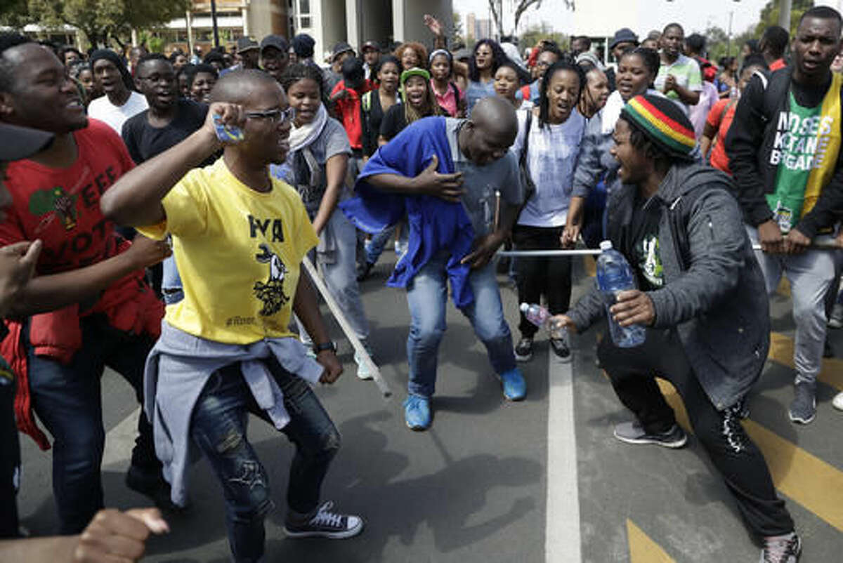 Students sing during their protest for free education in Johannesburg, South Africa, Tuesday, Sept. 20, 2016. South African university students who want free education are protesting on several campuses, and police have arrested at least 10 students who blocked an entrance at the University of the Witwatersrand in Johannesburg. (AP Photo/Themba Hadebe)