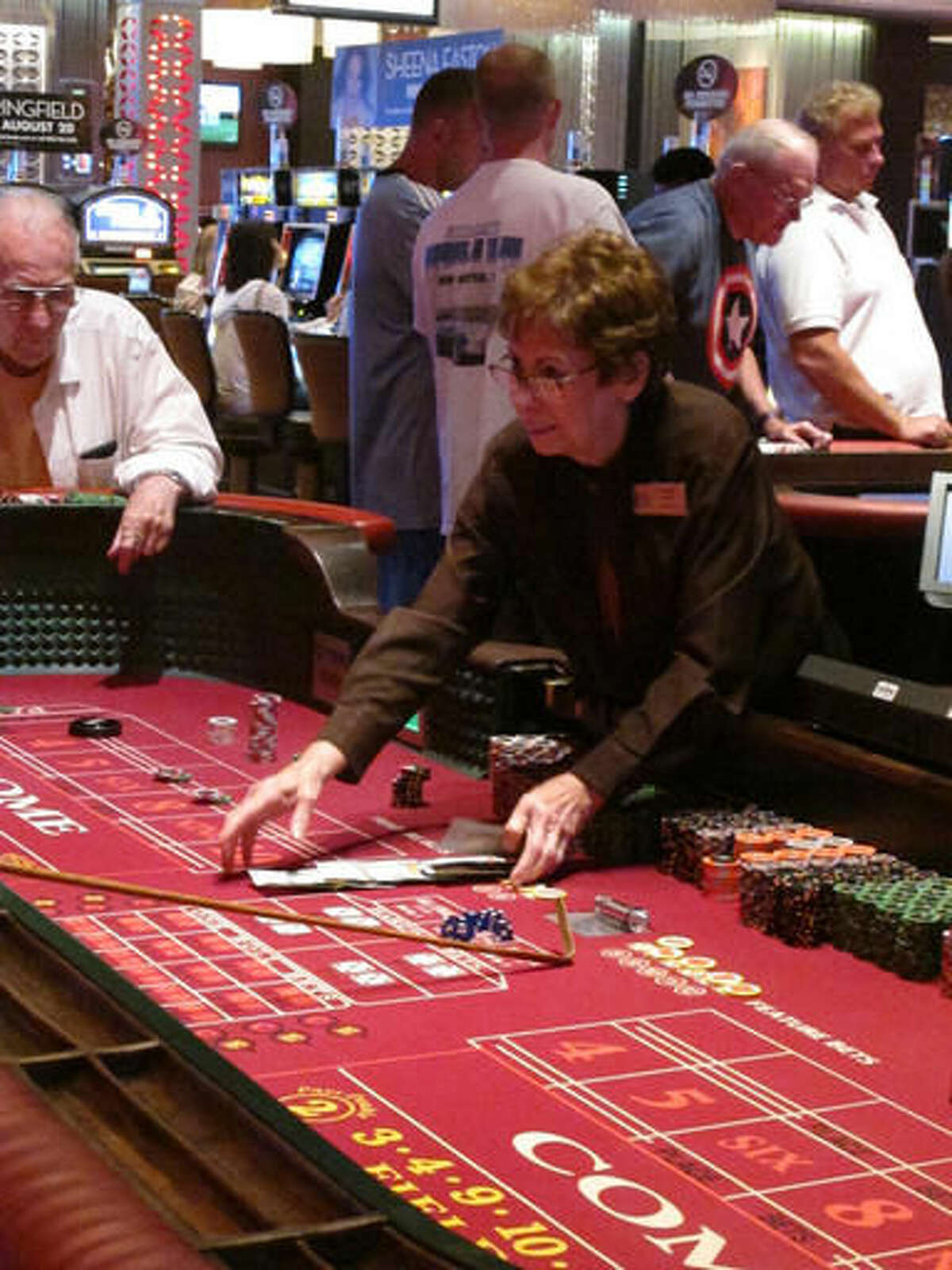 This June 24, 2016 photo shows a dealer conducting a craps game at the Golden Nugget casino in Atlantic City, N.J., where gambling revenue was up 6.4 percent in August to $23.8 million. Figures released by New Jersey gambling regulators on Wednesday Sept. 14 show that Atlantic City's eight casinos saw a collective decline of 4.9 percent in their August 2016 gambling revenue to $245.8 million compared with August 2015. (AP Photo/Wayne Parry)