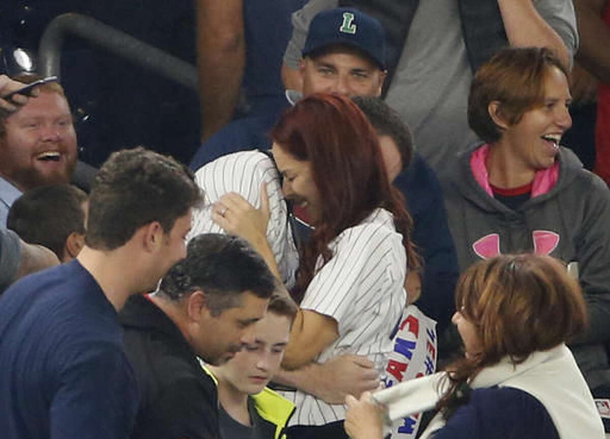 Heather Terwilliger and Andrew Fox embrace after the couple became engaged during a baseball game between the New York Yankees and the Boston Red Sox in New York, Tuesday, Sept. 27, 2016. Fox's first attempt went awry when he opened the box and the engagement ring was missing. Eventually the ring was located in the cuff of Terwilliger's pants. The second time was the charm. (AP Photo/Kathy Willens)