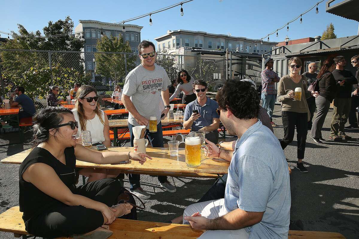 Students visiting from University of North Carolina including Thu Pham (left) have beers at Biergarten on Thursday, October 20, 2016, in San Francisco, Calif.