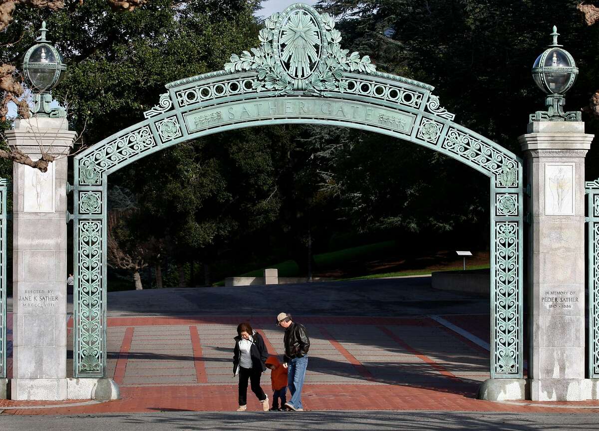 Visitors walk through Sather Gate at UC Berkeley.