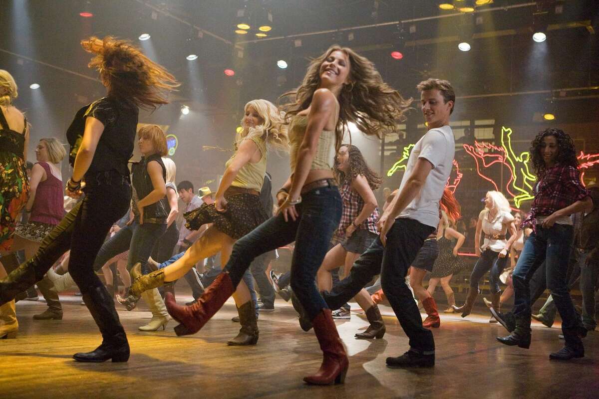 Julianne Hough, center, and Kenny Wormald are shown in a scene from "Footloose." The robot boxers of "Real Steel" and the dancers of "Footloose" are in a tight fight for the box-office title. "Real Steel" came in barely ahead of the remake "Footloose", which opened with $16.1million.(AP Photo/Paramount Pictures, K.C. Bailey)
