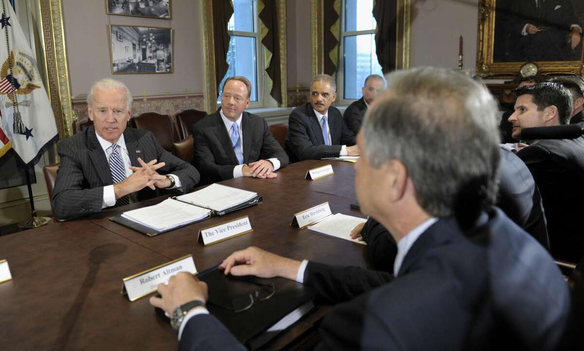 Vice President Joe Biden, left, with Attorney General Eric Holder, second from right, speaks during a meeting with representatives from the video game industry in the Eisenhower Executive Office Building on the White House complex in Washington, Friday, Jan. 11, 2013. (AP Photo/Susan Walsh)