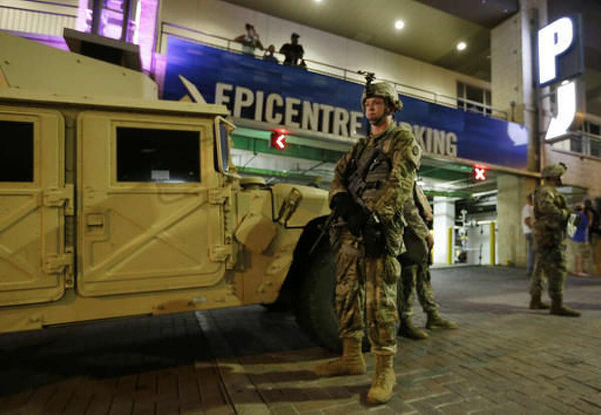 National Guardsman stand on the street in downtown Charlotte, N.C. on Thursday, Sept. 22, 2016. Charlotte police refused under mounting pressure Thursday to release video that could resolve wildly different accounts of the shooting of a black man, as the National Guard arrived to try to head off a third night of violence in this city on edge. (AP Photo/Chuck Burton)