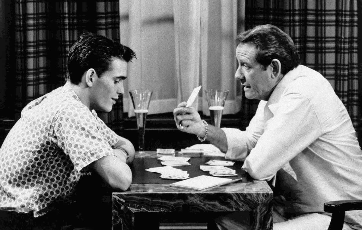 In this undated file photo, veteran actor Richard Crenna, right, and Matt Dillon play cards in scene from the 1984 film "The Flamingo Kid." (AP Photo/20th Century Fox, File)