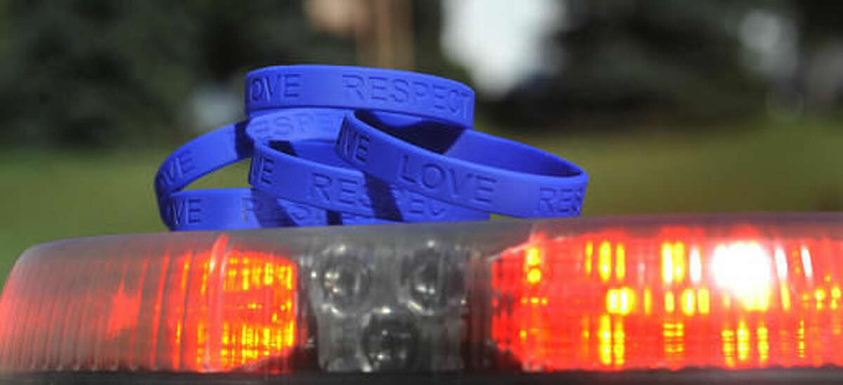 ADVANCE FOR USE SATURDAY, SEPT. 17 - In this Sept. 12, 2016 photo, blue wristbands with the words "Give, Love, Respect" are displayed in Johnstown, Pa. The wristbands were given to the Johnstown police force by an area business, hoping to encourage residents to work together with police. (Todd Berkey/The Tribune-Democrat via AP)