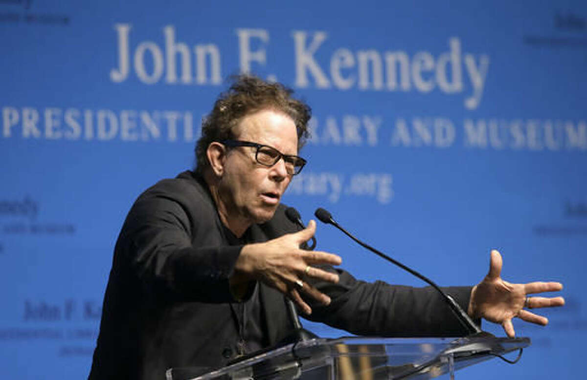 Musician Tom Waits addresses an audience after he and his wife musician Kathleen Brennan were presented with the PEN New England's Song Lyrics of Literary Excellence Award during ceremonies at the John F. Kennedy Library and Museum, Monday, Sept. 19, 2016, in Boston. (AP Photo/Steven Senne)