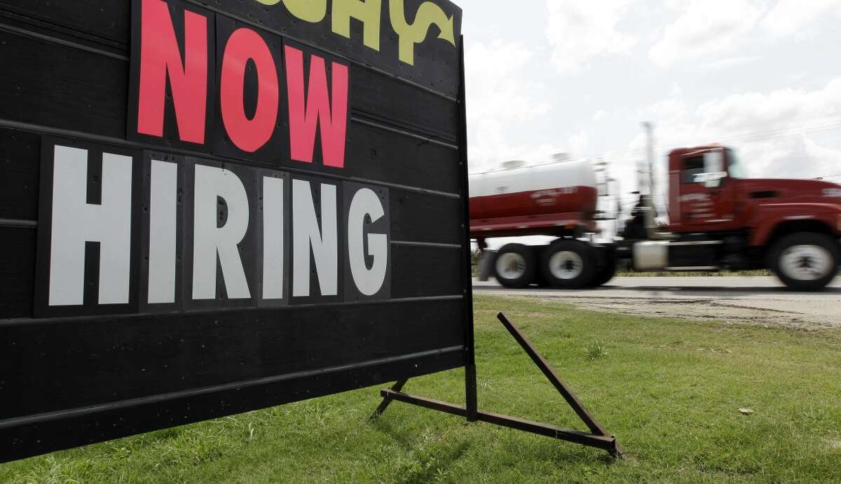 An oil truck passes a "now hiring" sign, Wednesday, May 9, 2012, in Kennedy, Texas. A UTSA report says South Texas's Eagle Ford Shale supported nearly 48,000 jobs last year while creating overnight boom towns cashing in on a $25 billion economic windfall. The energy rush that started in 2008 mushroomed into nearly 1,700 wells last year. (AP Photo, File/Eric Gay)