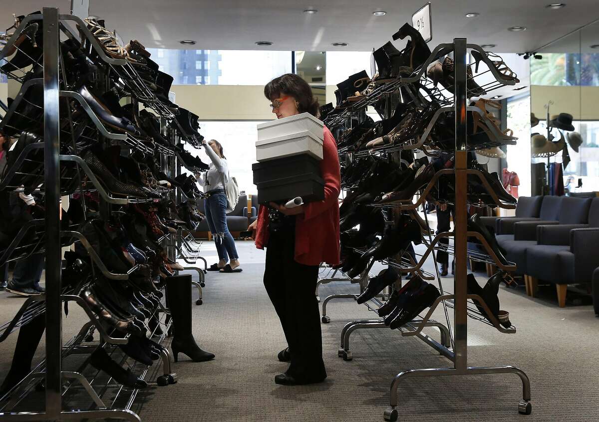 Sales Associate Tina Kastoras looks for a shoe while helping a customer inside Arthur Beren Shoes in Union Square Oct. 21, 2016 in San Francisco, Calif. The store, which opened in 1988 is facing closure due to lost revenue and rising rents.