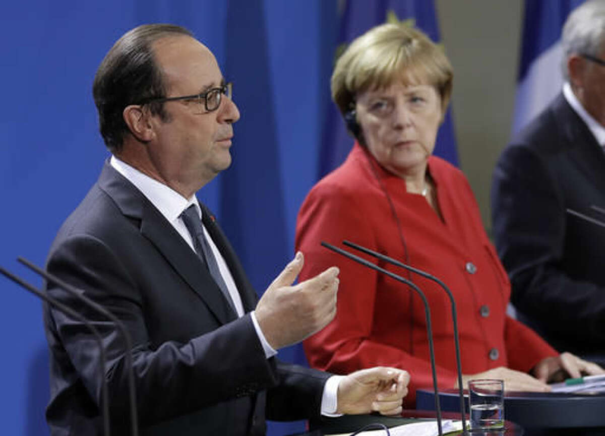 French President Francois Hollande speaks as German Chancellor Angela Merkel, right listens during press statements prior to a meeting of German Chancellor Angela Merkel, French President Francois Hollande and European Commission President Jean-Claude Juncker with representatives of the European Round Table of Industrialists in the chancellery in Berlin, Germany, Wednesday, Sept. 28, 2016. (AP Photo/Michael Sohn)