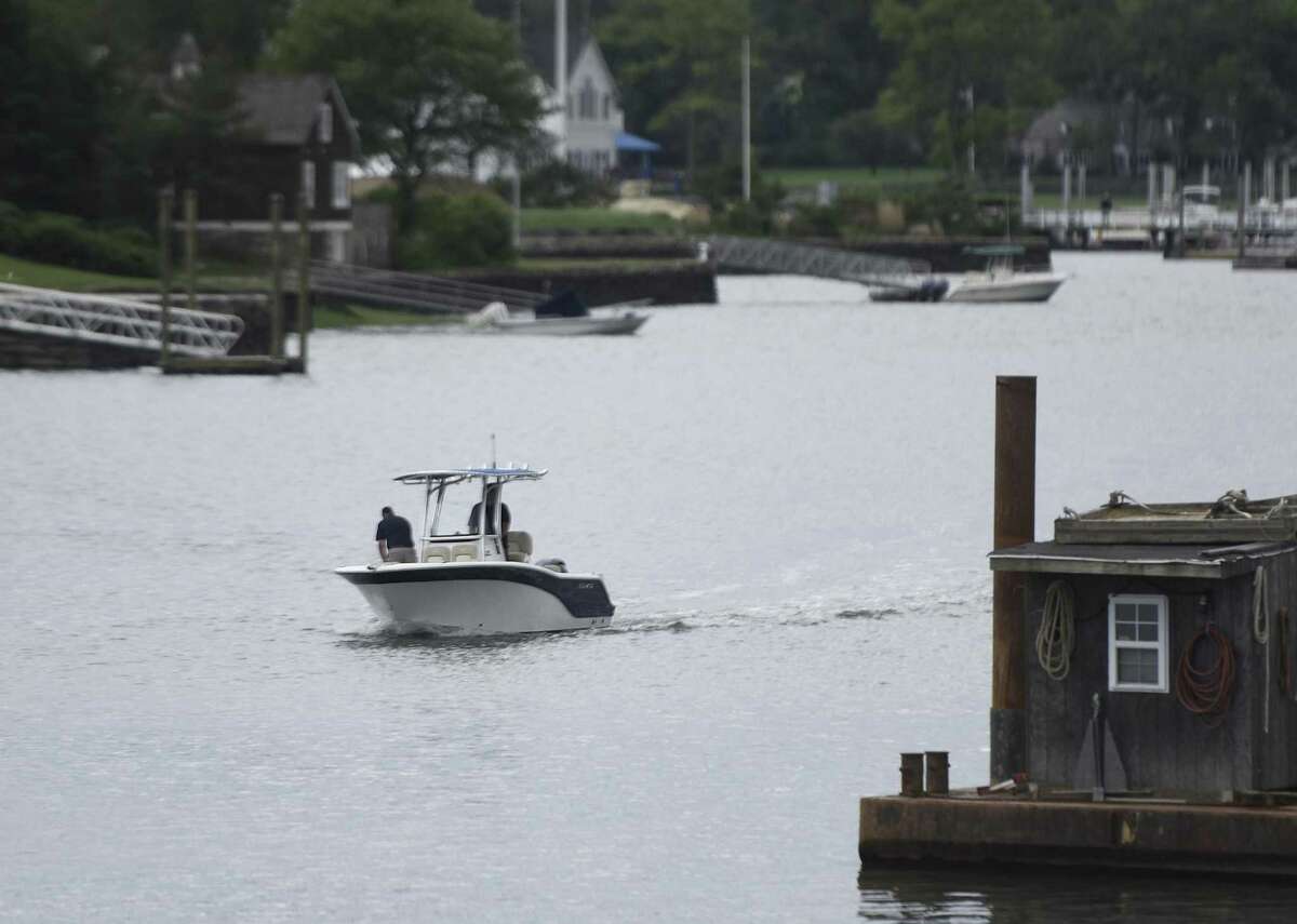 A boat returns to the Cos Cob Harbor near Cos Cob Park in Greenwich, Conn. Wednesday, June 8, 2016. Officials say a long-awaited project to dredge the harbor will begin as soon as the weather allows, possibly Monday.